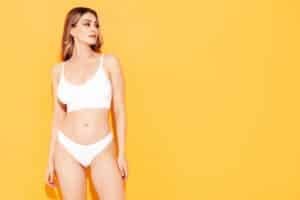 Woman showing a toned figure after a mommy makeover