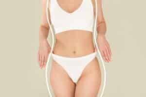 Woman showing slim waist and toned body after liposuction