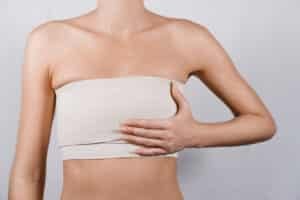 Woman showing breast reduction results after surgery.